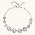 Sterling silver bracelet with graduated heart-shaped links and sparkling moissanite stones in VVS1 clarity on white background.